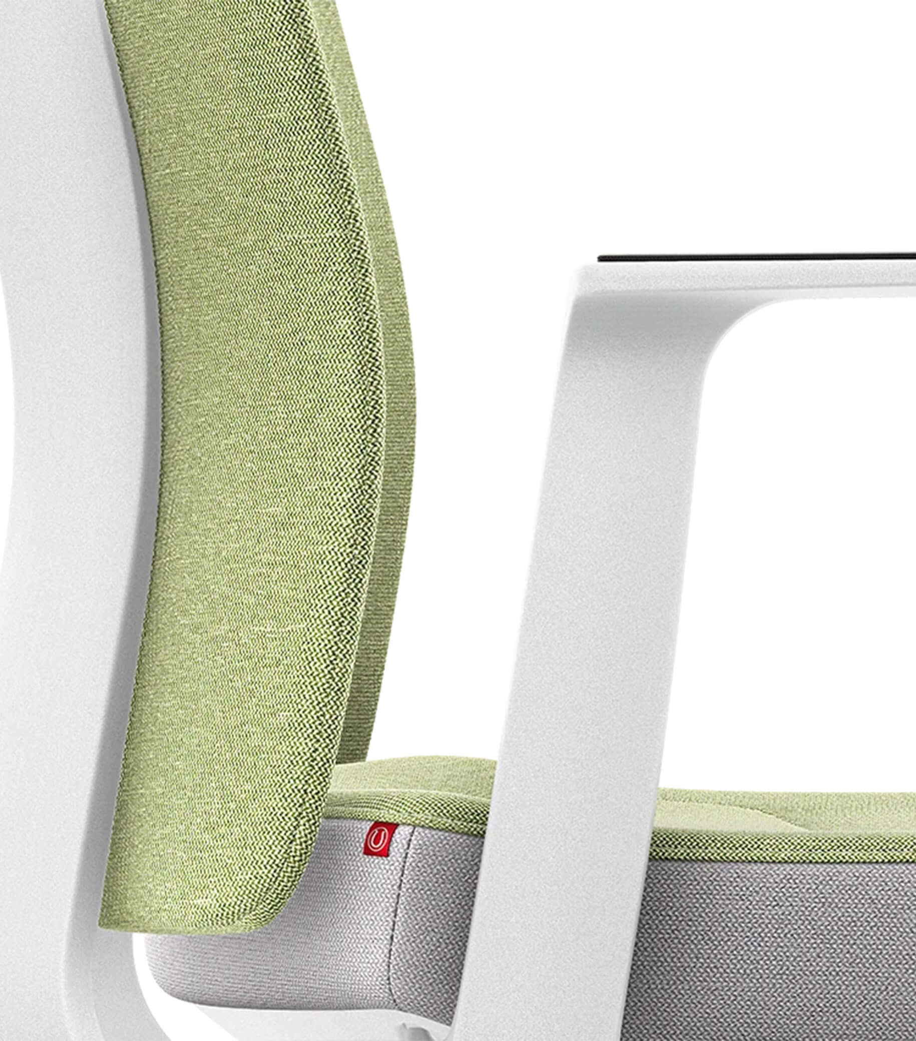 PURE Interior Edition #04 chair with Smart-Spring, ergonomic padded backrest, green upholstery, and white frame.