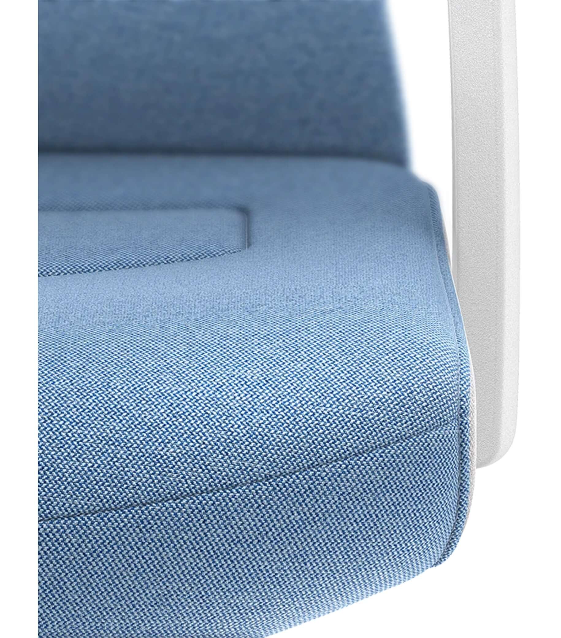 Close-up of blue upholstered chair seat with white armrest, featuring Smart-Spring technology for ergonomic comfort and flexibility.