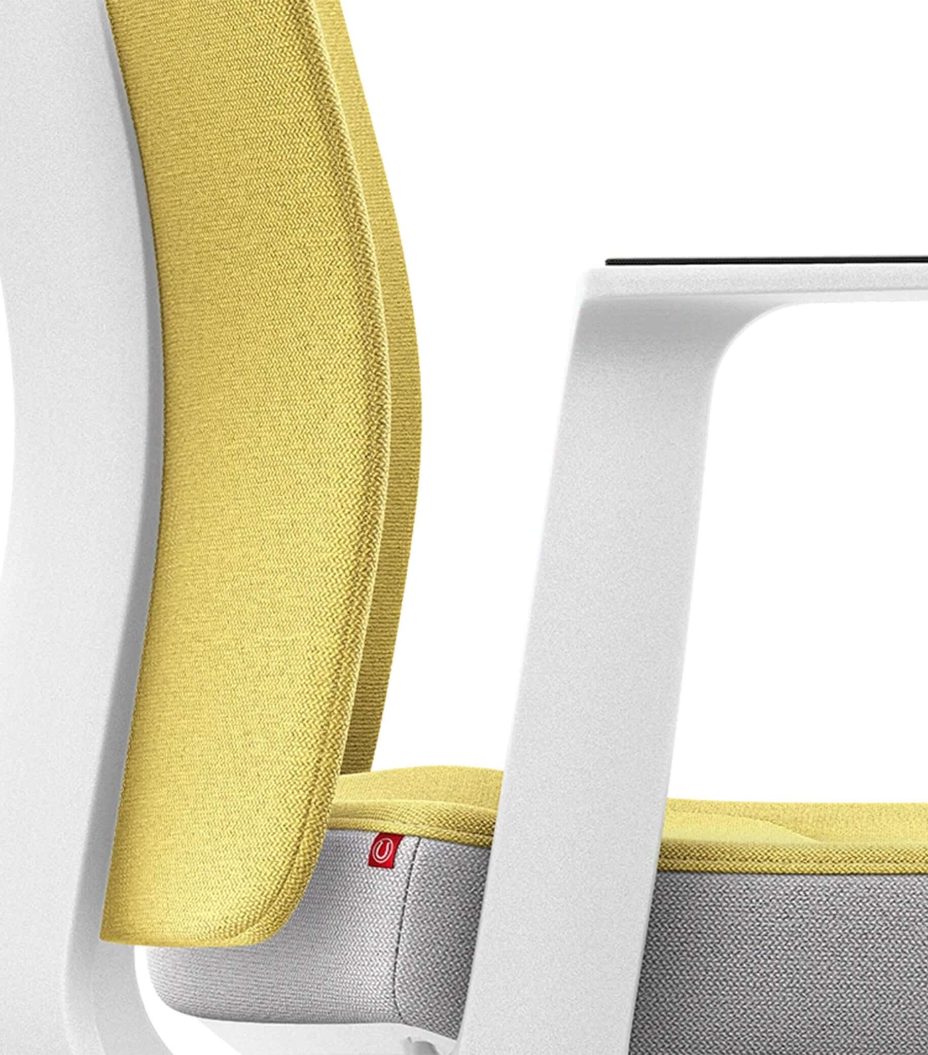 White ergonomic chair with yellow padded backrest featuring Smart-Spring technology for active seating and enhanced mobility.