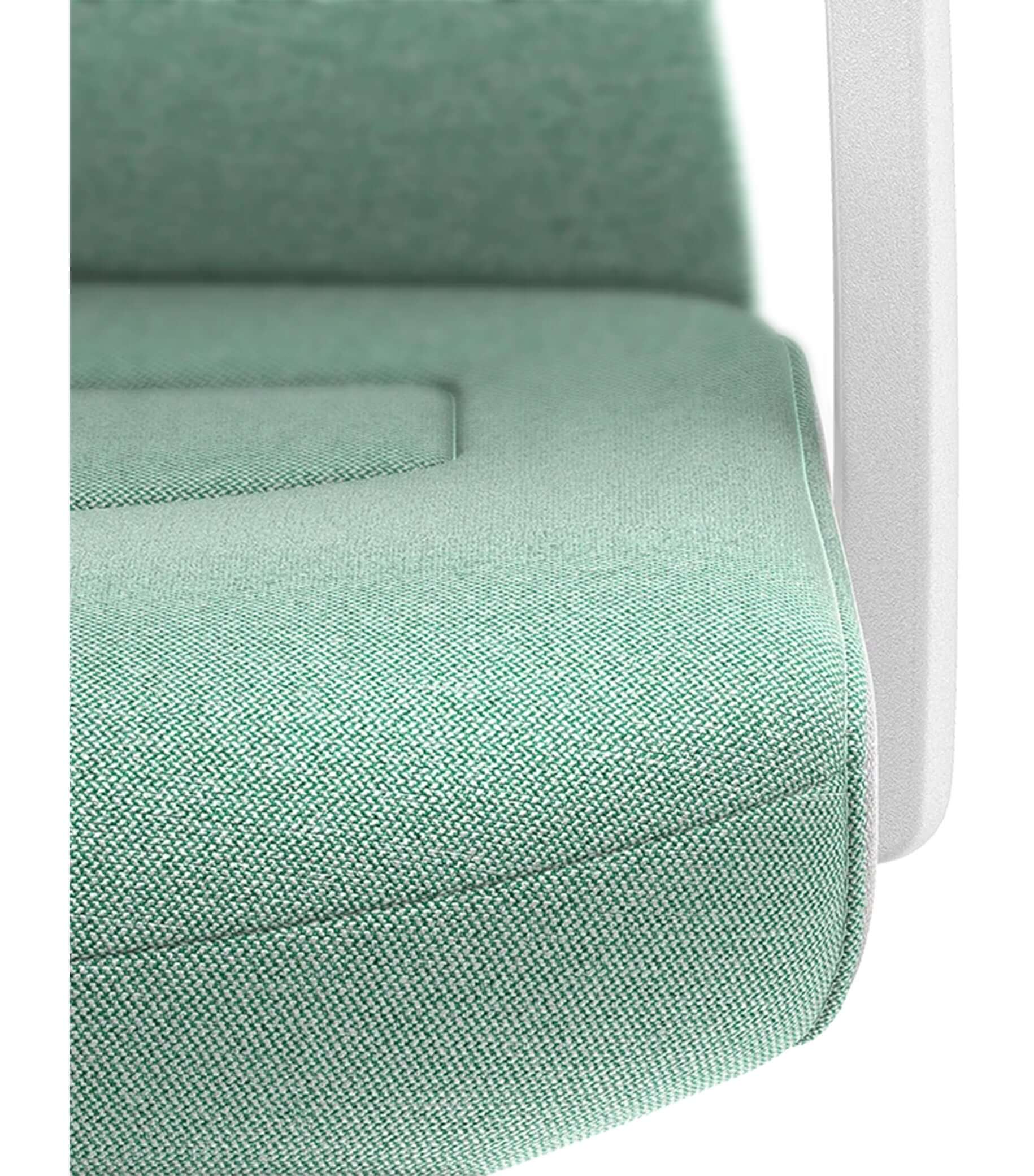 Close-up of padded armrest on a PURE Interior chair featuring Smart-Spring technology, with green Era upholstery.