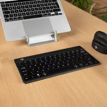 Ergo-R Black mini keyboard on desk beside laptop and mouse, highlighting compact ergonomic design.