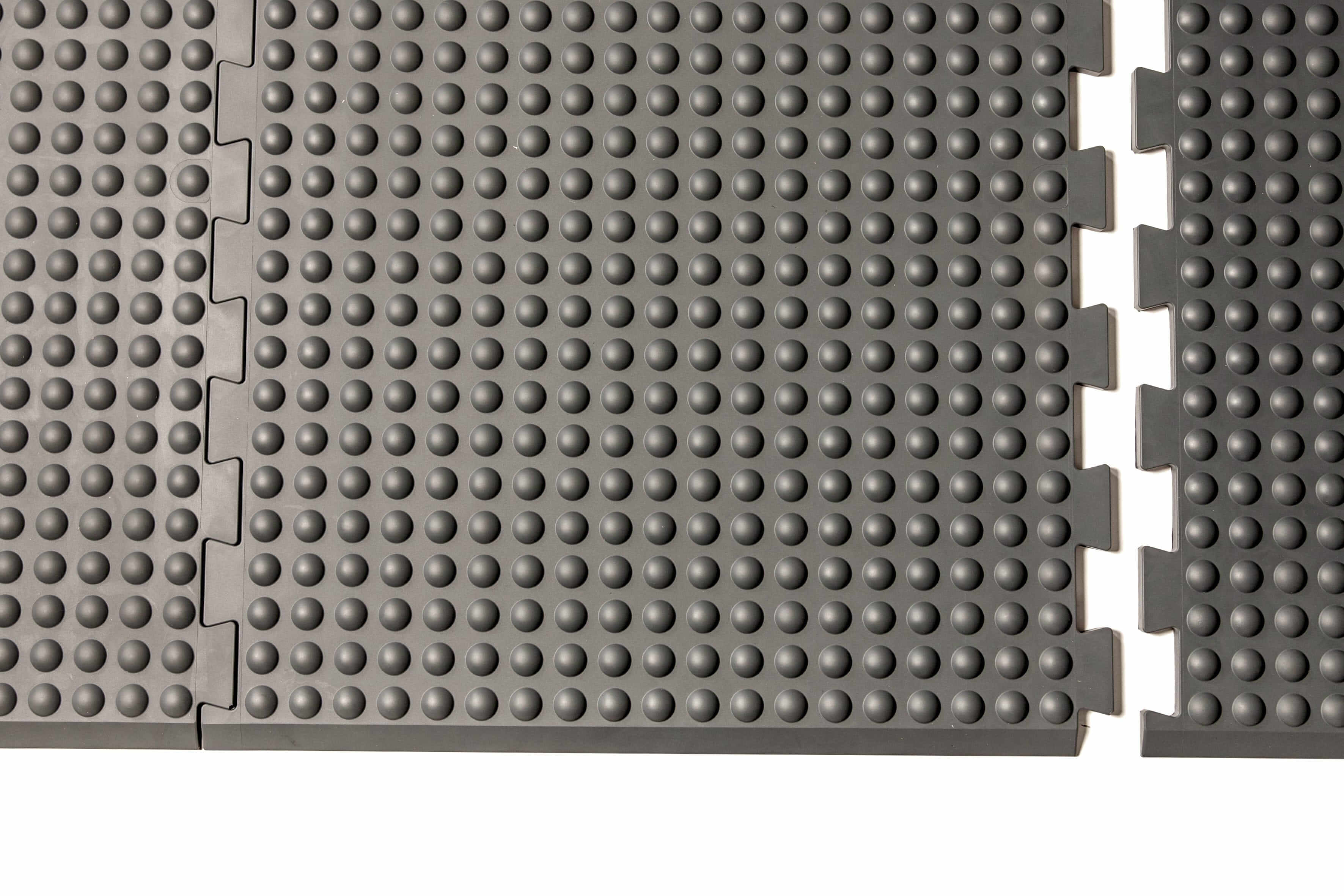 Grey GetUpMat Puzzle extension piece showing interlocking design for customizable standing mat arrangement.
