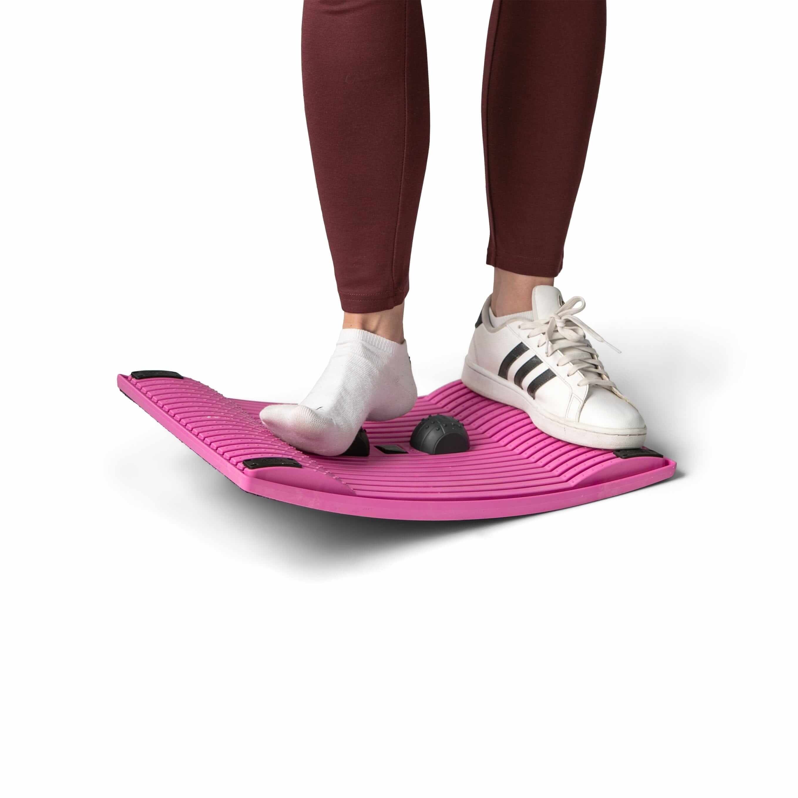 Person using pink activation board to exercise and improve circulation and concentration at the workplace.