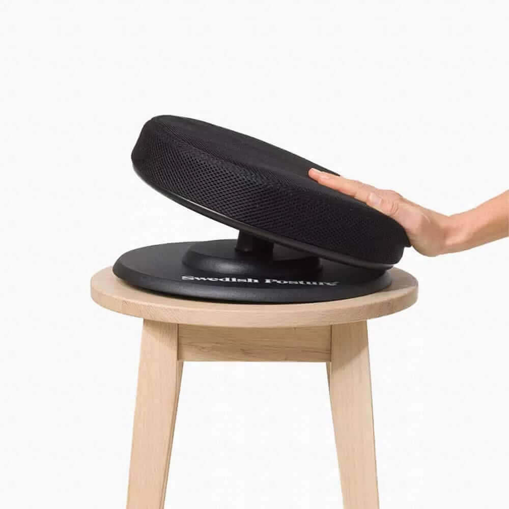 Posture Balance active seat on stool showing round base for dynamic movement and core muscle engagement.