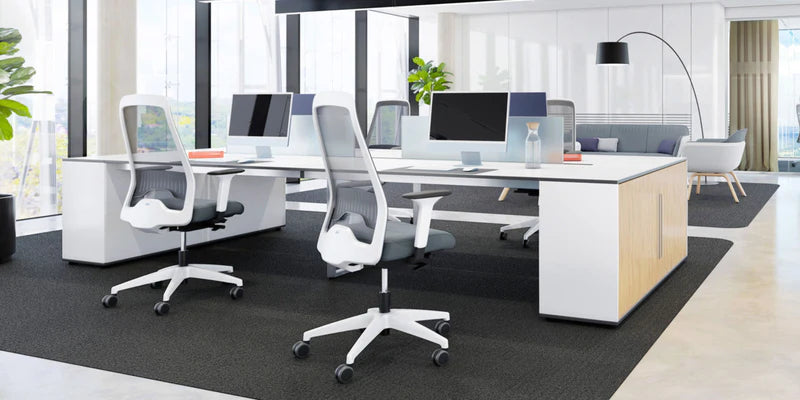 Modern ergonomic office chairs with adjustable features in a contemporary open office setting.