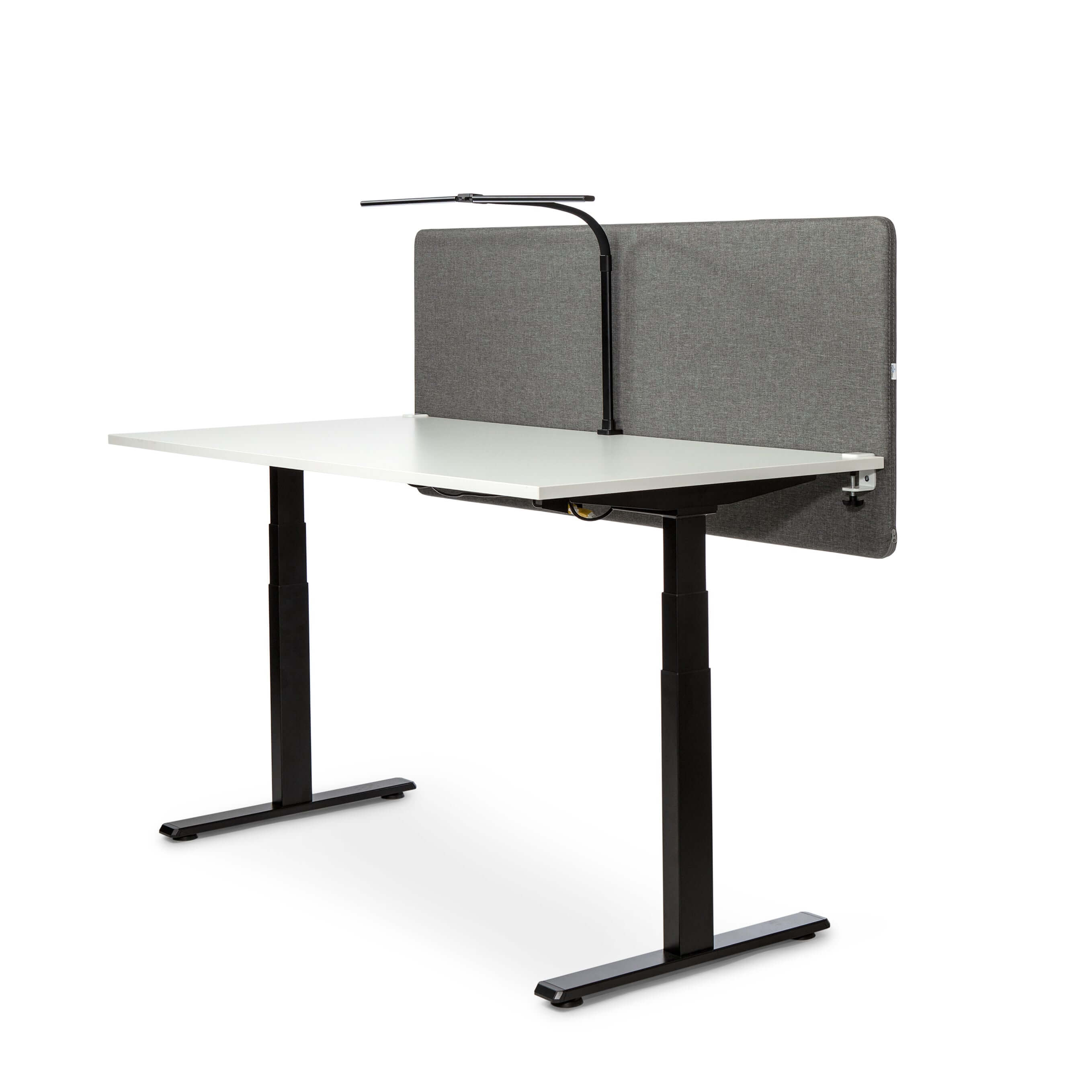 Black Duo LED desk lamp attached to a modern adjustable white desk with a grey divider in a minimalist office setting.