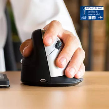 Left-handed wireless R-Go HE vertical mouse on desk, reducing wrist strain and preventing RSI.