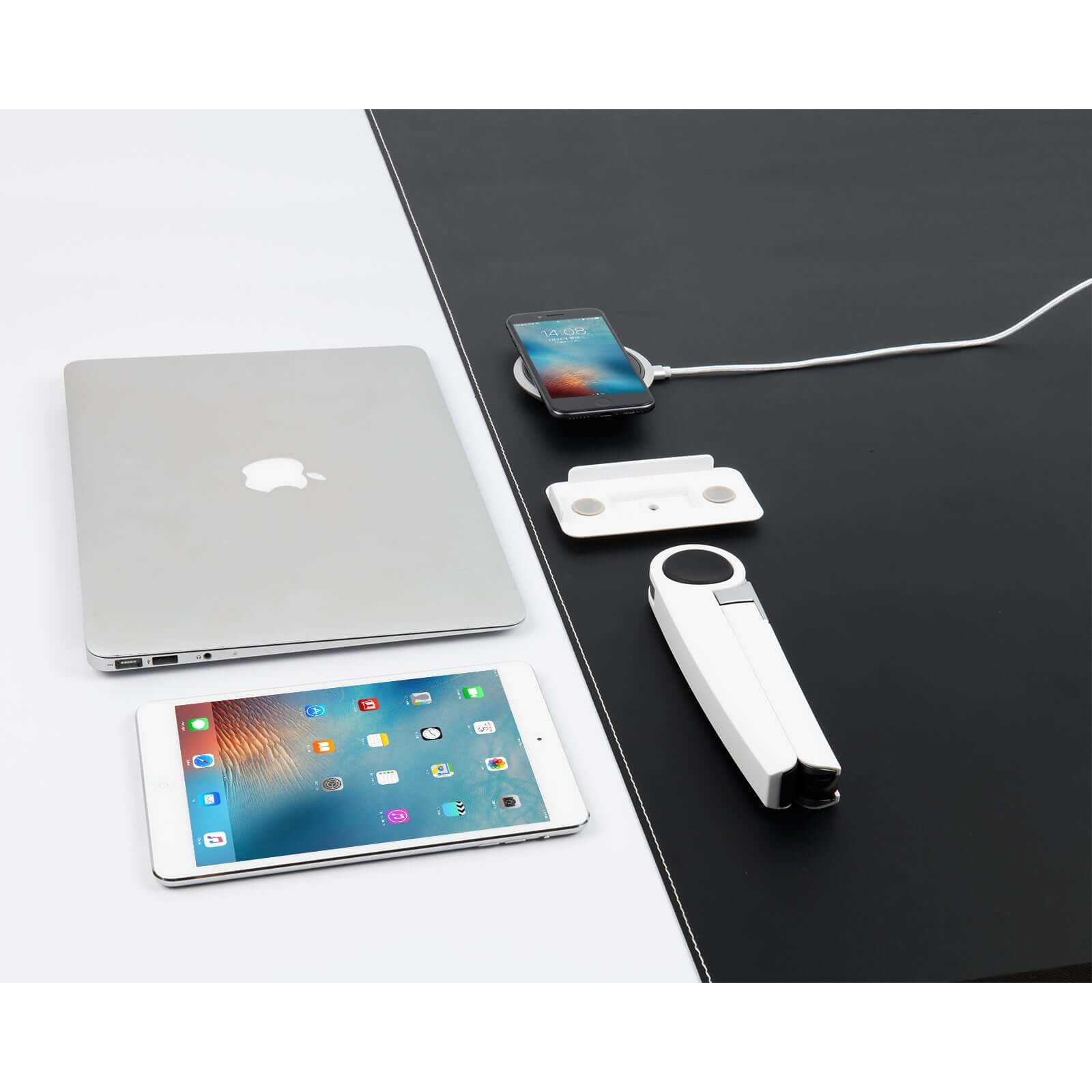 White Spider laptop and tablet stand with a smartphone and laptop on a sleek black and white desk setup.