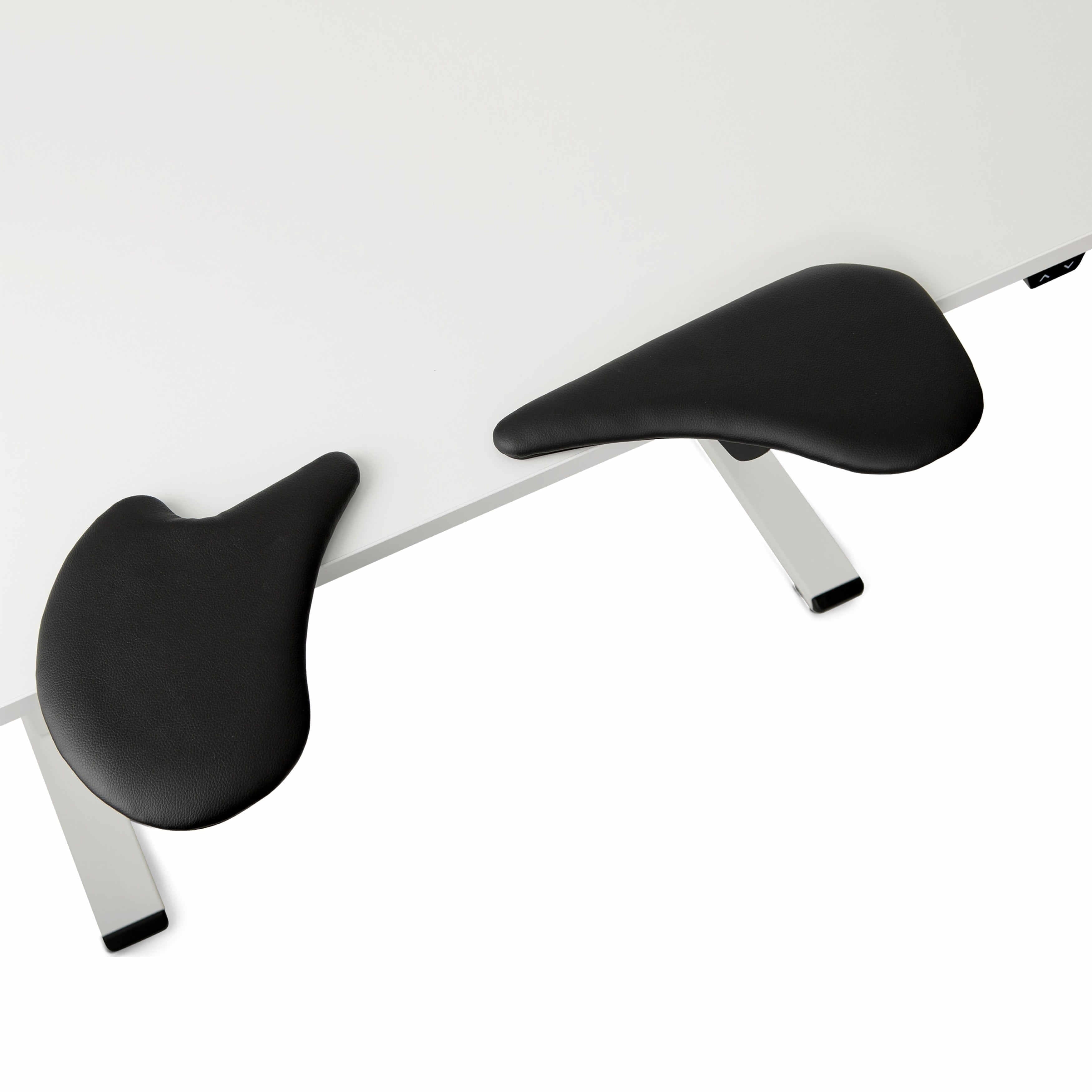 Adjustable lycra arm support pads on white desk for ergonomic comfort and customization.