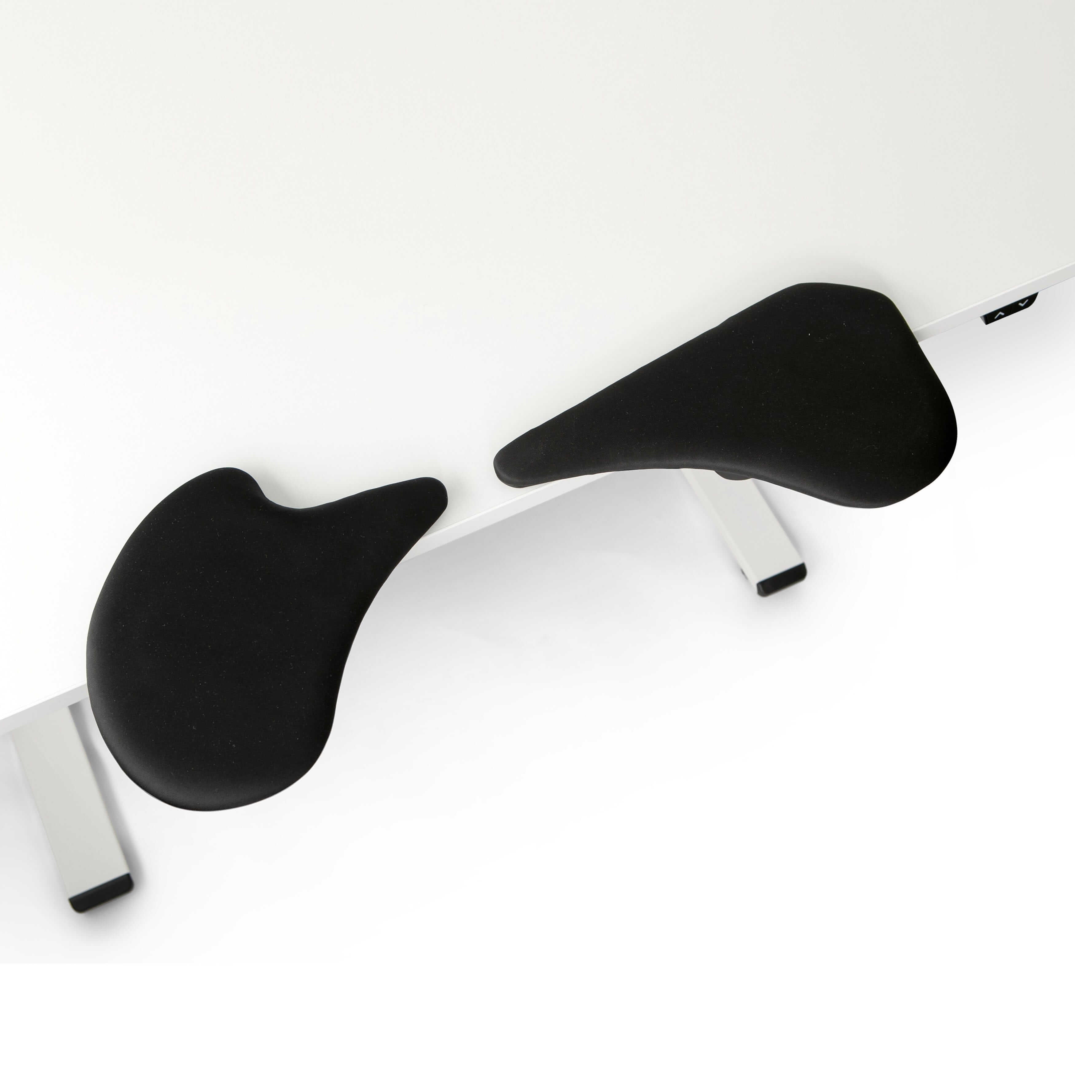 Black lycra 2-part arm support attached to a white table.