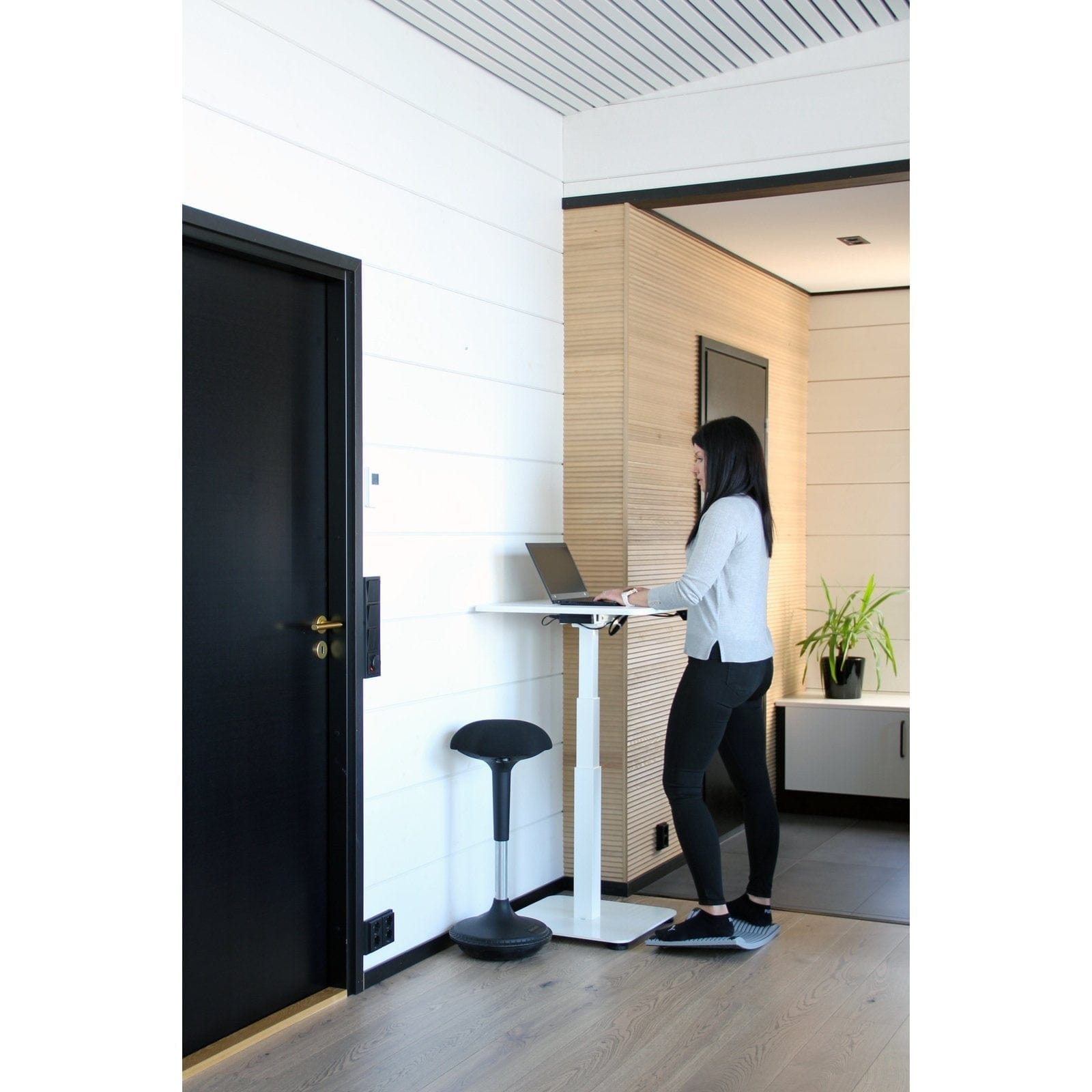 person using GetUpDesk Single electric desk for standing work in modern office space