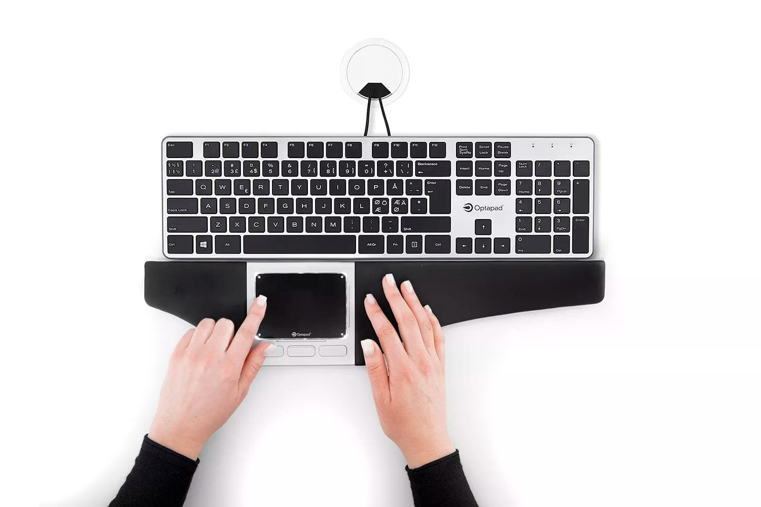 Ergonomic centered mouse with touchpad and wrist support in use with keyboard.