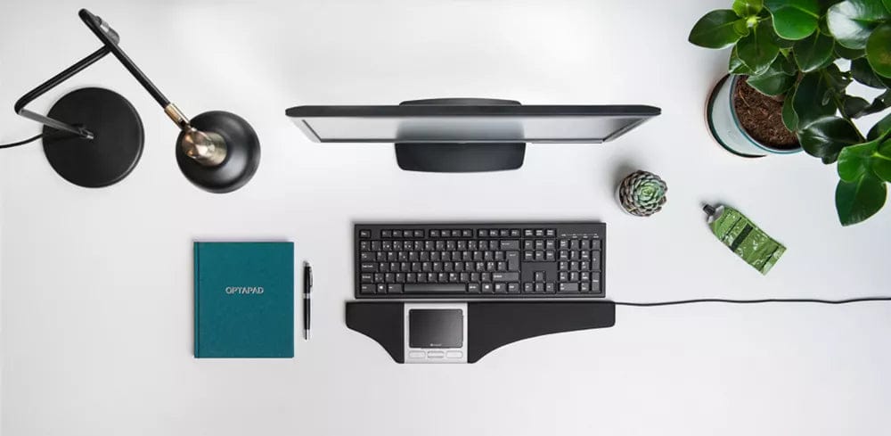 Ergonomic desk setup featuring Optapad Original centered touchpad mouse with soft wrist supports placed in modern workspace.